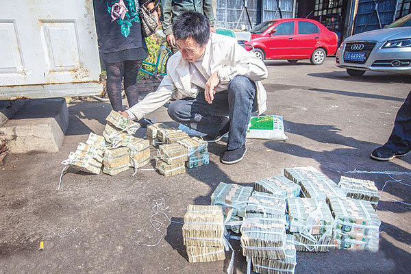 李广国面对4万张面值1元纸币的赔偿金，气愤之余还有些无奈。