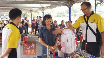 遗孀邦妮给亡夫上香。