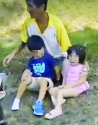 一名华裔男子正看顾两名孩童,女童吓得嚎啕大哭。(取自网络视频截图)
