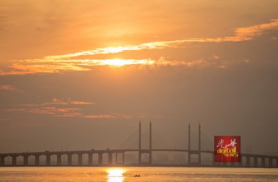 摄影爱好者从班台惹雅码头拍摄日出时,拍到海豚嬉戏。