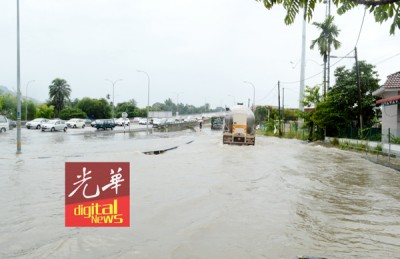 阿尔玛高架桥往武吉敏惹方向,左侧路口淹水,只有大罗里能安然通过。