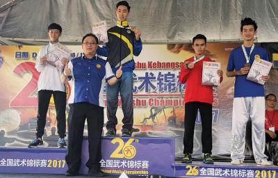 方万春(左二)为男子组太极拳优胜者颁奖,并为槟队首金得主何永光(中)感到开心。
