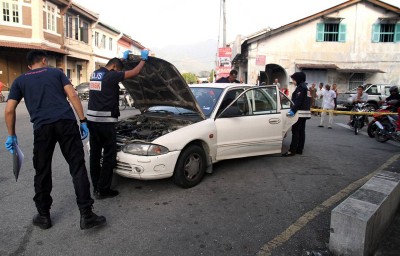 警方截停一辆停放在该店附近的轿车。(马新社图片)