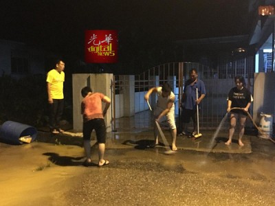 居民在水势退后漏夜清理屋子。