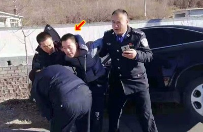 警官合力将韩继华(箭嘴示)制服。