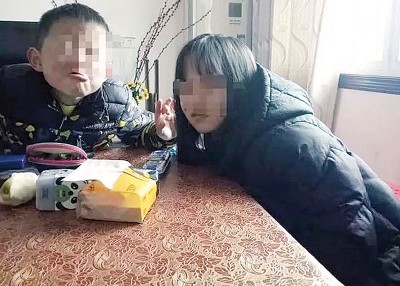 萍萍（右）生前与弟弟玩耍的生活照。