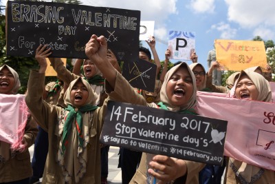 Muslim students shout slogans during a protest against Valentine's Day celebrations in Surabaya, Indonesia