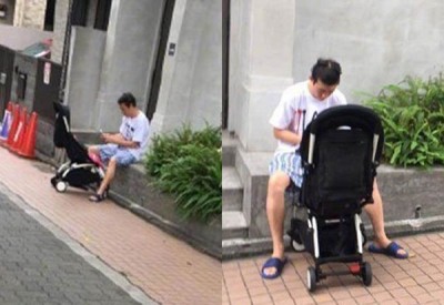 陈冠希在日本街头推女儿娃娃车散步。