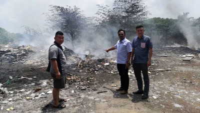 :（右起）王泽钦、安努亚、周诚国巡视公开焚烧地点，剩余火种仍在冒烟燃烧。