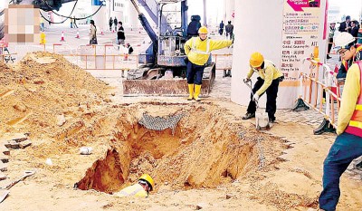 其中较大面积的地陷位置，工程人员在深逾两米的地洞内抢修。
